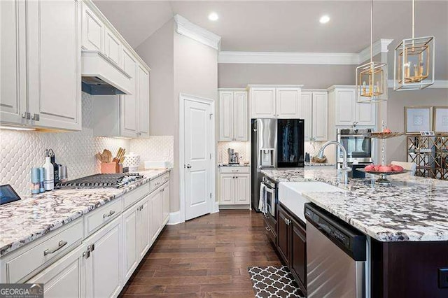 kitchen with white cabinetry, stainless steel appliances, crown molding, and decorative light fixtures