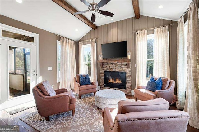 living room with hardwood / wood-style floors, lofted ceiling with beams, and ceiling fan