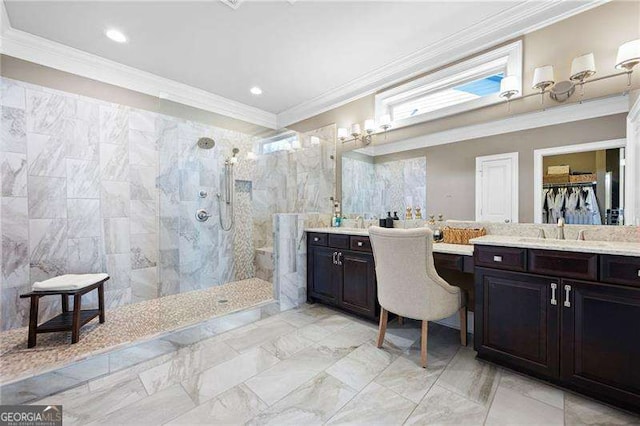 bathroom featuring crown molding, tiled shower, and vanity