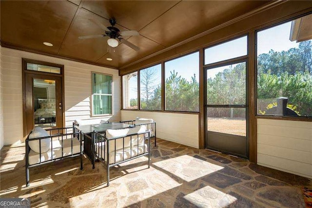 sunroom with a wealth of natural light and ceiling fan