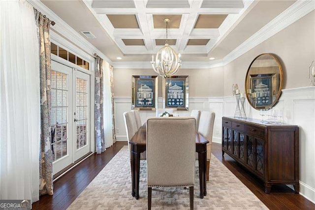 dining room with an inviting chandelier, dark hardwood / wood-style flooring, coffered ceiling, beam ceiling, and french doors