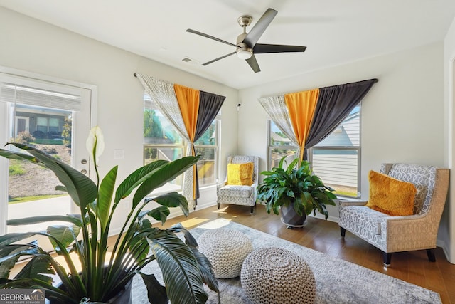 sitting room featuring dark hardwood / wood-style floors and ceiling fan