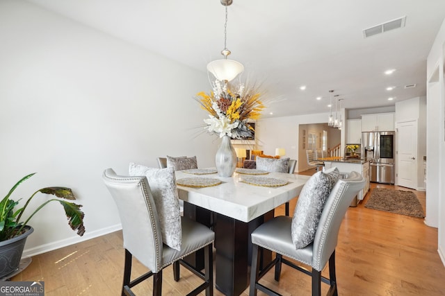 dining area with light hardwood / wood-style floors