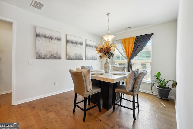 dining space with hardwood / wood-style flooring