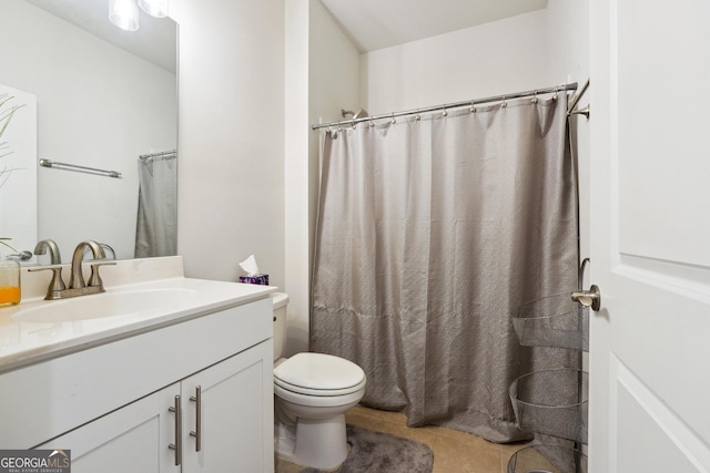 bathroom featuring vanity, tile patterned flooring, and toilet