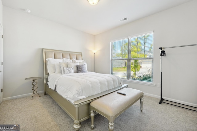 bedroom featuring light colored carpet