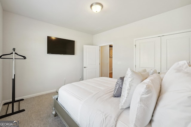 bedroom with a closet and light carpet