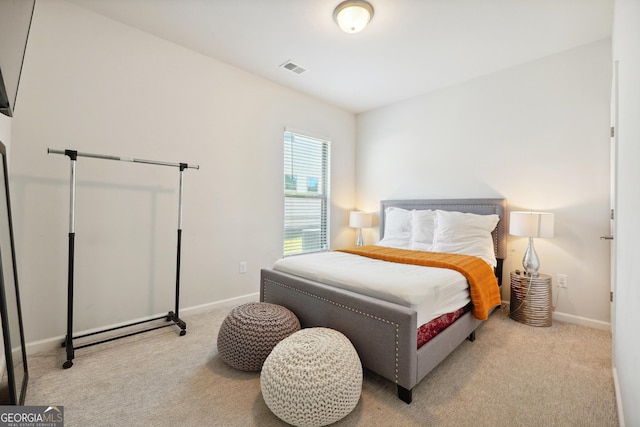 bedroom featuring light carpet