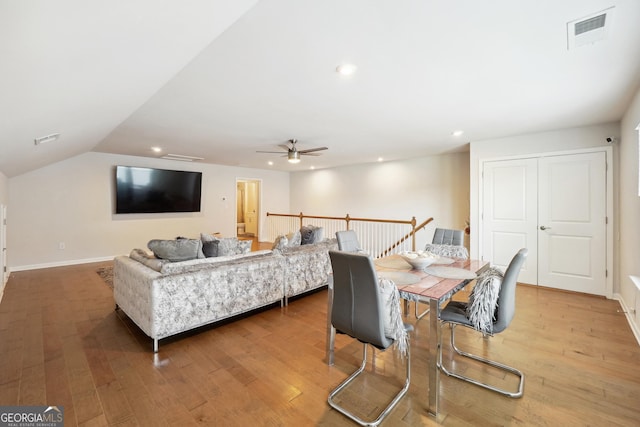 dining space featuring vaulted ceiling, ceiling fan, and hardwood / wood-style floors