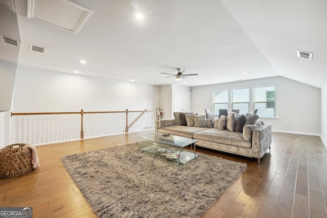 living room featuring hardwood / wood-style flooring, ceiling fan, and lofted ceiling