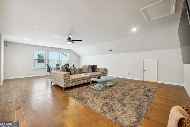 living room featuring ceiling fan, dark hardwood / wood-style flooring, and vaulted ceiling