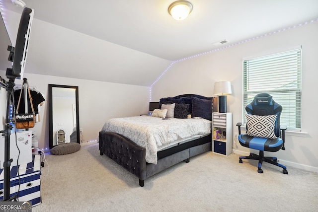 bedroom featuring carpet floors and vaulted ceiling