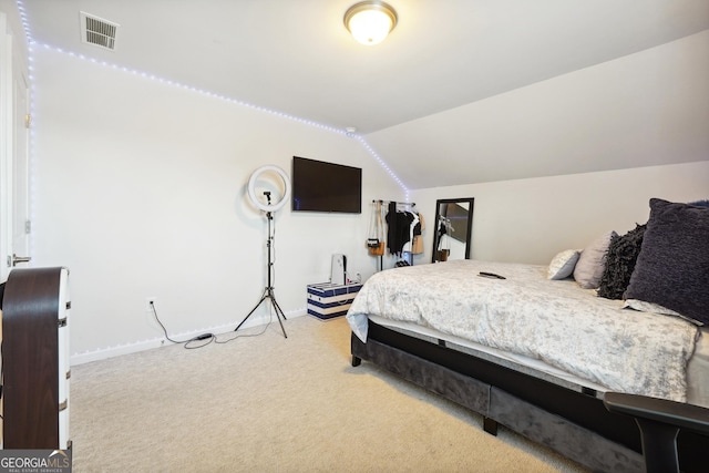 carpeted bedroom featuring vaulted ceiling