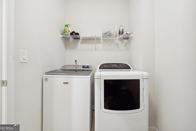 clothes washing area featuring washing machine and clothes dryer