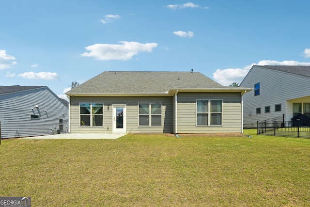 rear view of property with a lawn and a patio area