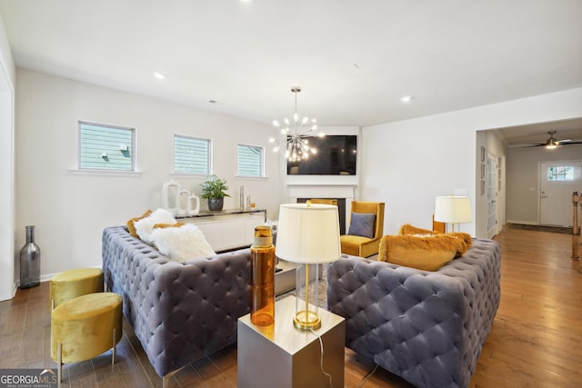 living room with an inviting chandelier and dark hardwood / wood-style flooring