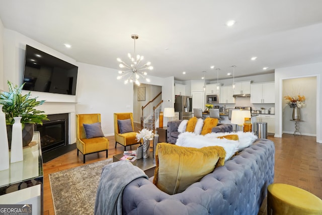 living room featuring hardwood / wood-style floors and a notable chandelier