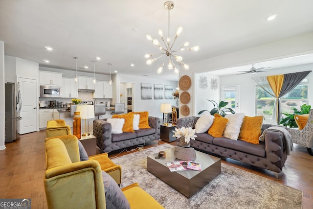 living room featuring wood-type flooring and a chandelier