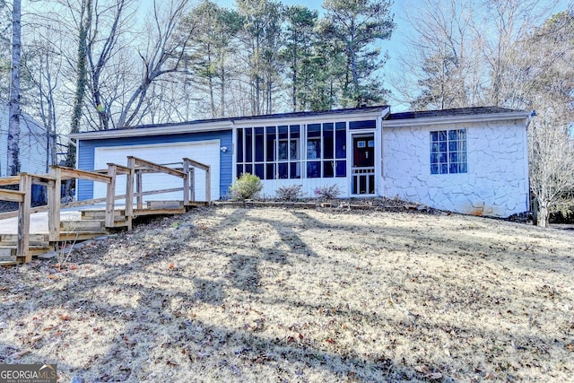 view of front facade with a deck and a sunroom