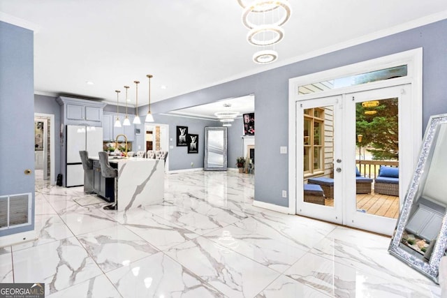 unfurnished dining area with crown molding and french doors