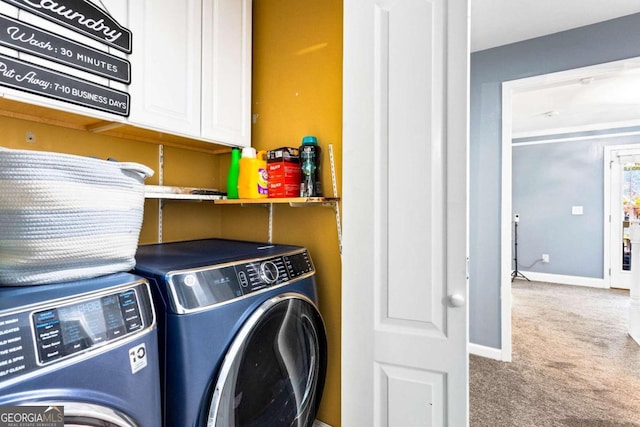 laundry room with carpet floors, cabinets, and washing machine and clothes dryer