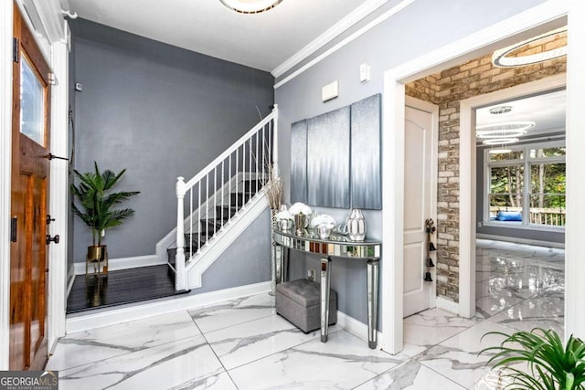 entrance foyer with crown molding and brick wall