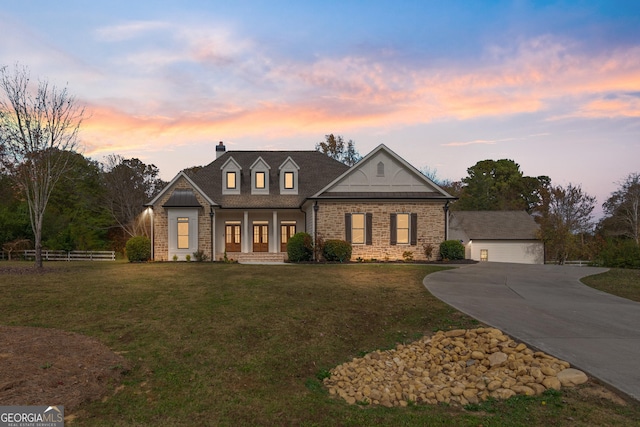 view of front of property featuring a garage and a yard