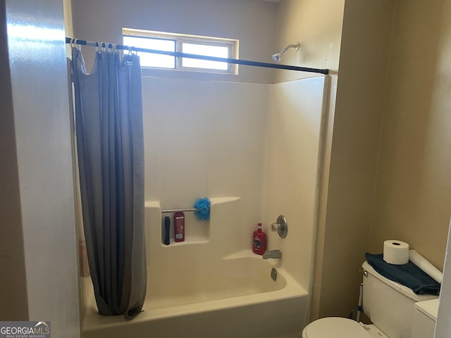 bathroom featuring shower / bathtub combination with curtain and toilet