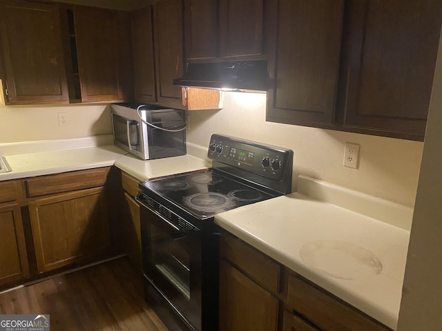 kitchen with dark hardwood / wood-style flooring and black range with electric cooktop