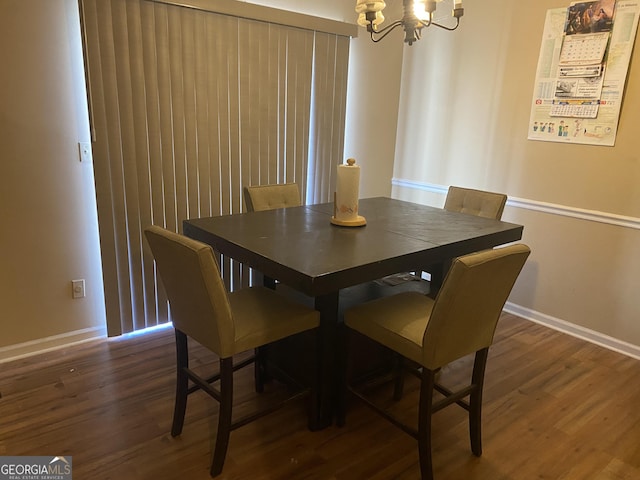 dining room featuring an inviting chandelier and dark hardwood / wood-style flooring