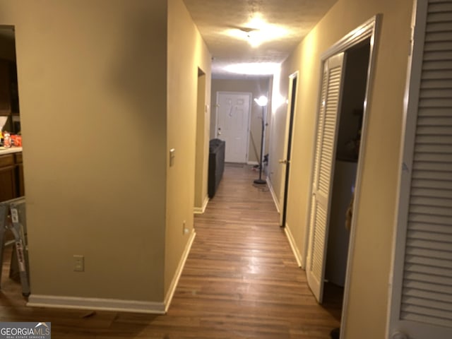 corridor featuring hardwood / wood-style floors