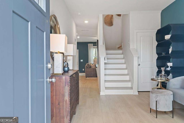 foyer entrance with light wood-type flooring