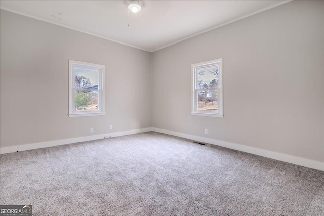 carpeted empty room with ornamental molding