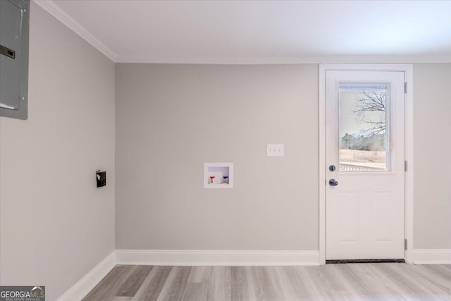 laundry room featuring washer hookup, light hardwood / wood-style flooring, and ornamental molding