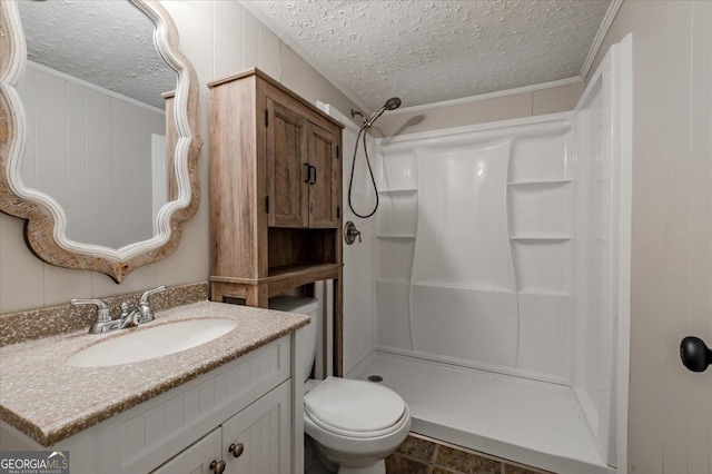 bathroom featuring vanity, walk in shower, toilet, crown molding, and a textured ceiling