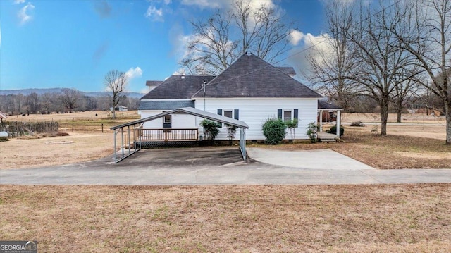 back of house with a lawn