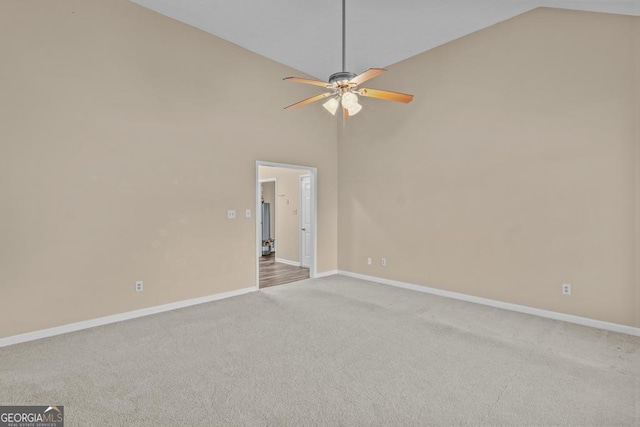 unfurnished room with ceiling fan, light colored carpet, and high vaulted ceiling