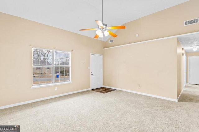 carpeted spare room featuring high vaulted ceiling and ceiling fan