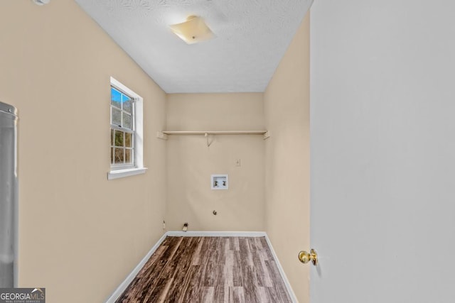 laundry room with hookup for a washing machine, gas dryer hookup, hardwood / wood-style flooring, and a textured ceiling