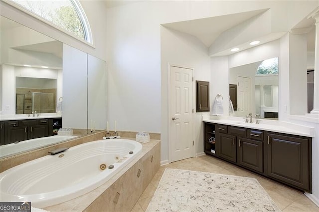 bathroom with vanity, plenty of natural light, and separate shower and tub