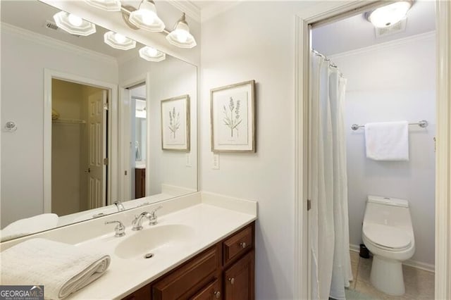 bathroom with vanity, crown molding, tile patterned floors, and toilet