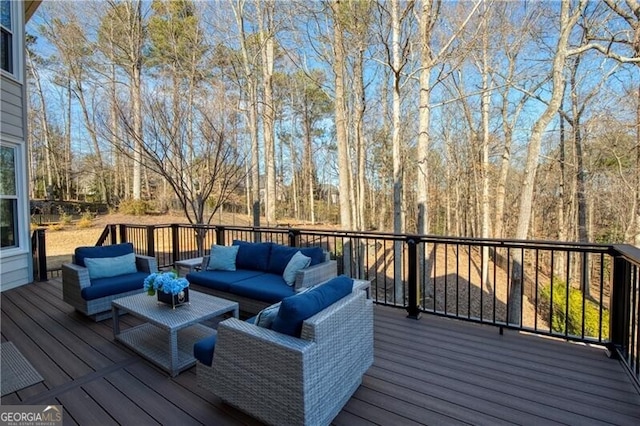 wooden terrace with an outdoor living space