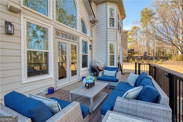 wooden terrace featuring an outdoor hangout area, grilling area, and french doors