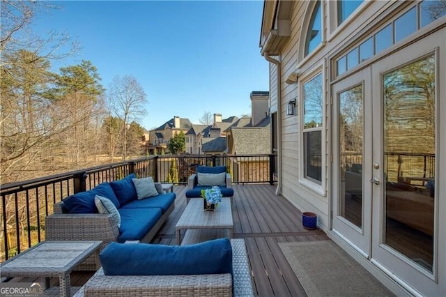 wooden terrace featuring outdoor lounge area and french doors