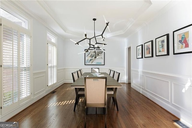 dining room with crown molding, a notable chandelier, and dark hardwood / wood-style flooring