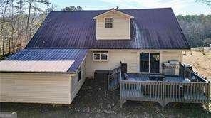 back of house with a wooden deck