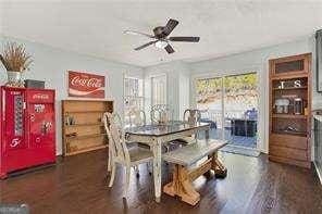 dining space featuring dark wood-type flooring and ceiling fan