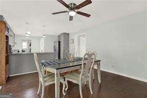 dining space with dark hardwood / wood-style floors and ceiling fan