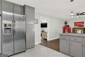 kitchen featuring gray cabinetry and stainless steel built in refrigerator