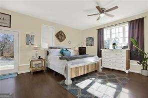 bedroom featuring ceiling fan and dark hardwood / wood-style floors